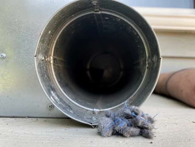 Santa Fe Springs Dryer Vent Cleaning technician using specialized equipment to clear severe dryer vent blockage in Santa Fe Springs